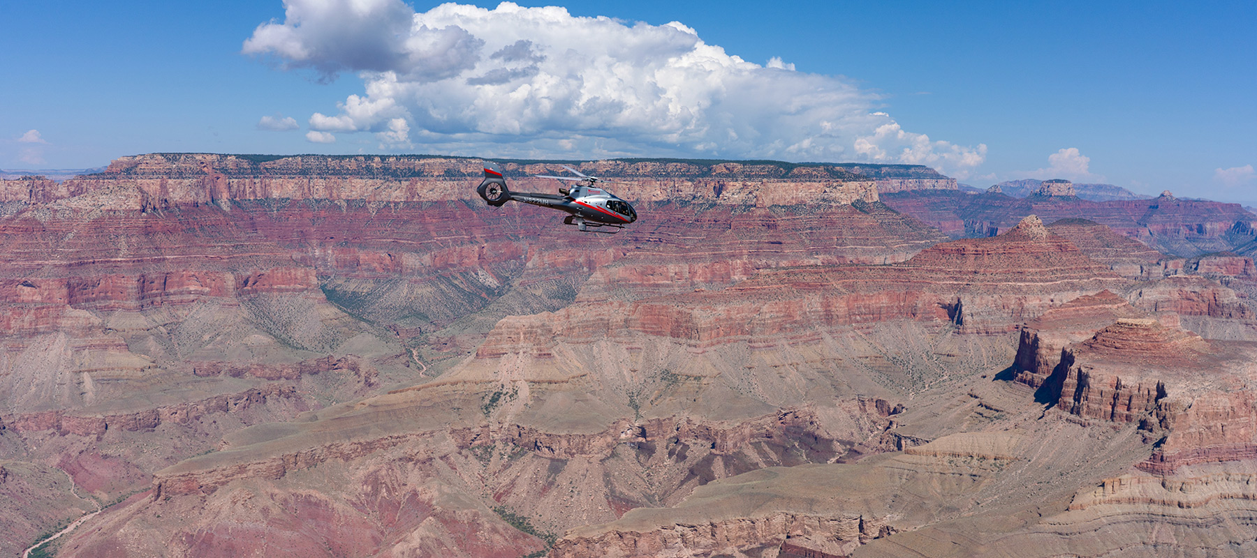 Expansive Grand Canyon landscape with red rock cliffs and canyon valleys