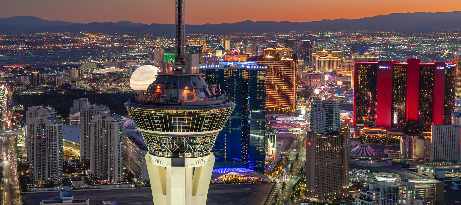 Las Vegas Strip glowing with colorful lights during a nighttime helicopter flight