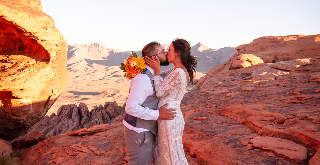 Couple sharing a kiss after exchanging vows during their Valley of Fire helicopter wedding