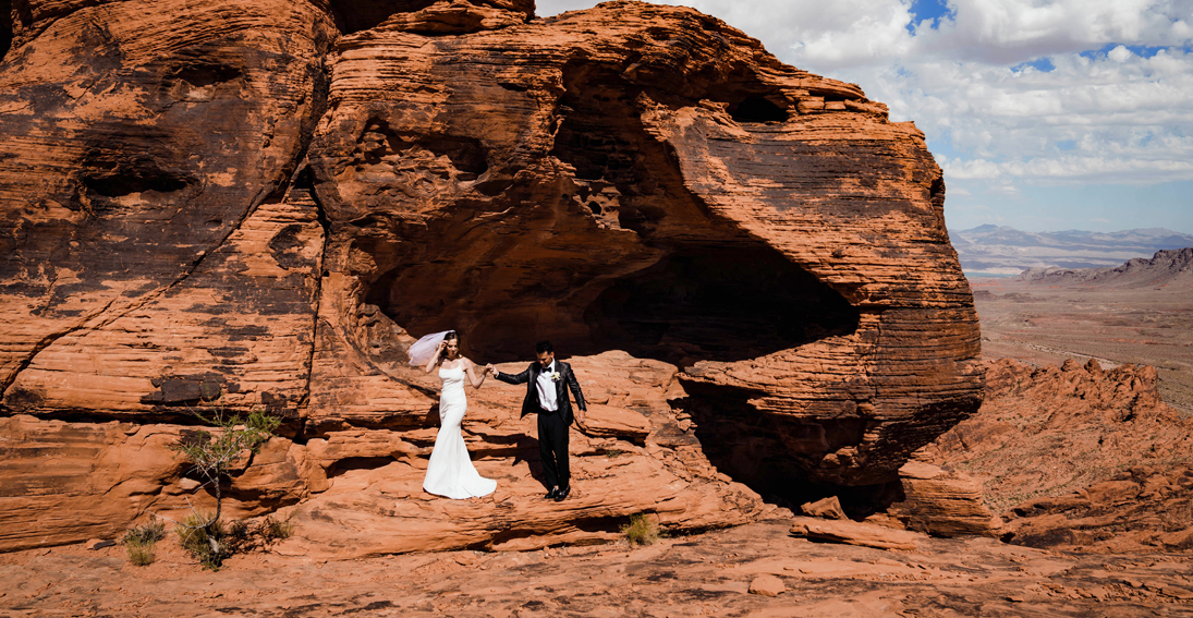 A beautiful couple surrounded by the stunning beauty of Valley of Fire during their Maverick helicopter wedding