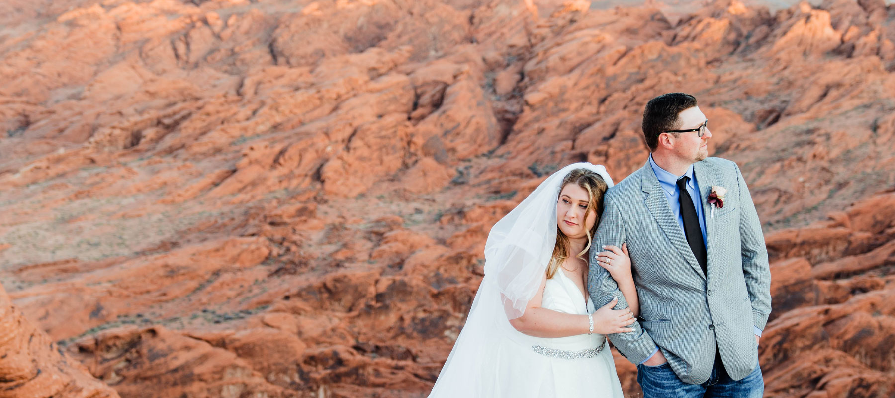 A couple celebrating their Sunset Brilliance wedding with Grand Canyon views behind them