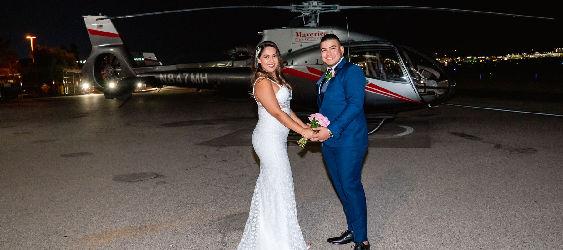 A romantic portrait of the wedding couple with the Las Vegas skyline glowing behind them