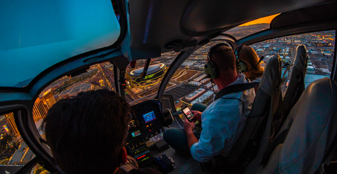 The wedding party enjoys the neon lights of Las Vegas on their private helicopter ride